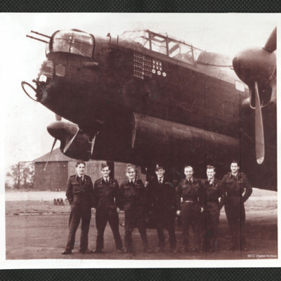 Seven aircrew in front of a Lancaster