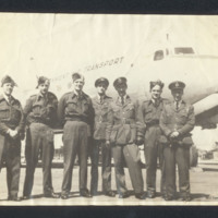 Seven personnel in front of an aircraft