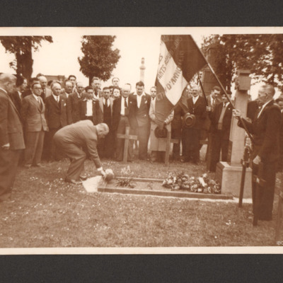 Man placing flowers on a grave