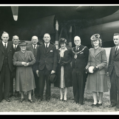 Roy Chadwick and  eight people in front of a Lancaster