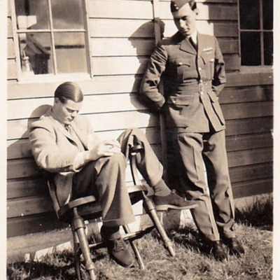 Two men outside a hut