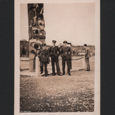 Three RAF officers in front of a totem pole