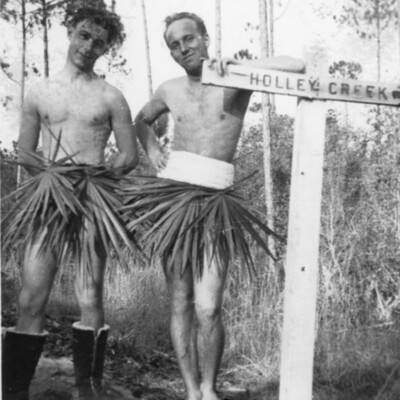 Two men in grass skirts