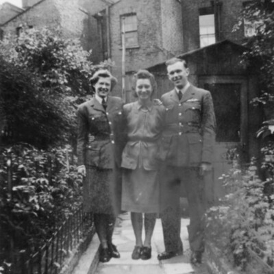 An RAF Officer, Women&#039;s Auxiliary Air Force officer and another woman standing on a path