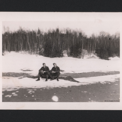 Two Airmen on a Log