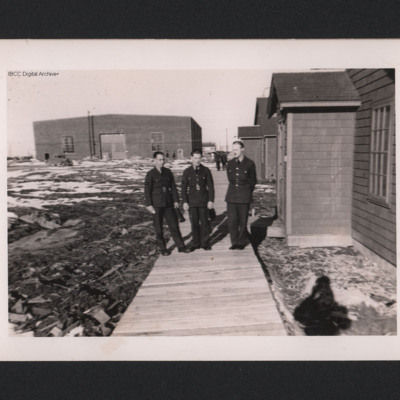 Three Airmen outside their Hut