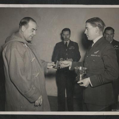 Man being presented with a silver tankard