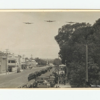 Military parade with three twin engined aircraft flypast