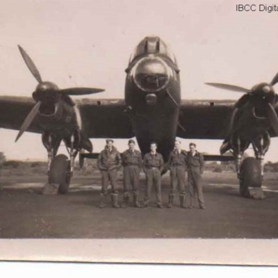 Five airmen in front of a Lancaster
