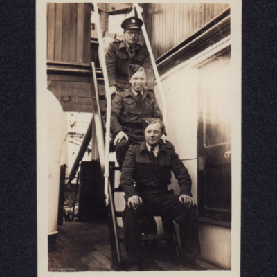 Group of three sitting on a ladder
