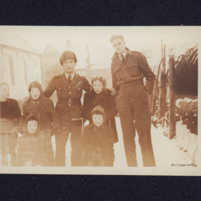 Two airmen with group of children