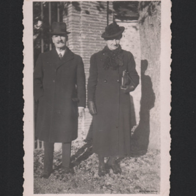 Man and woman in front of a brick building