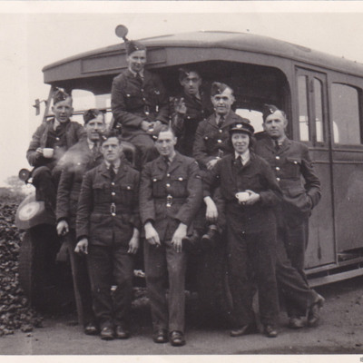 Airmen and a WAAF with a bus