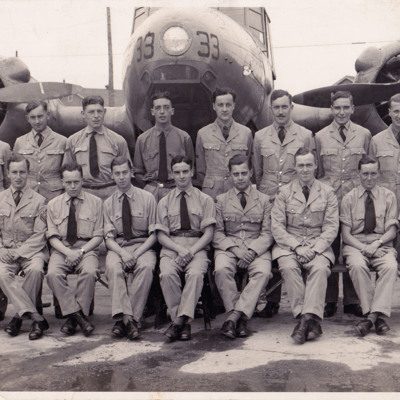 A large group of airmen in front of an Anson