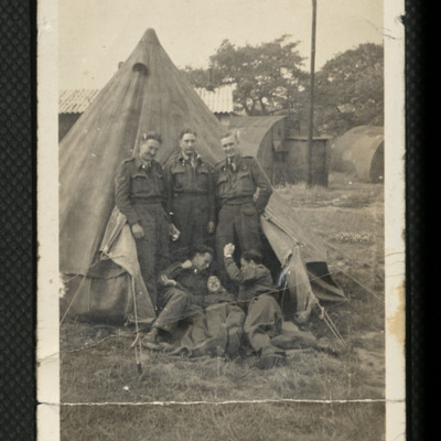 Six airmen by tent