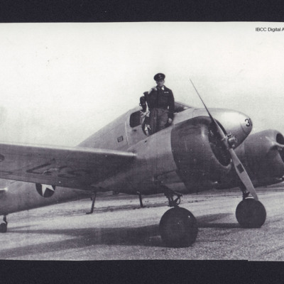 Pilot standing on wing of an aircraft