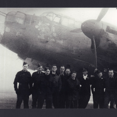 11 airmen standing in front of a Lancaster 