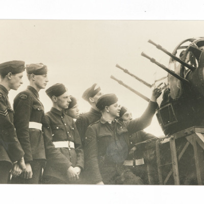 Airmen inspecting a machine gun turret