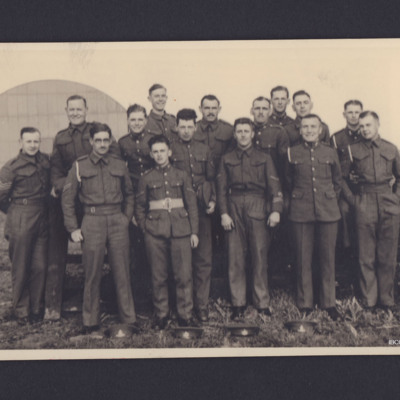 15 servicemen with a hangar behind them