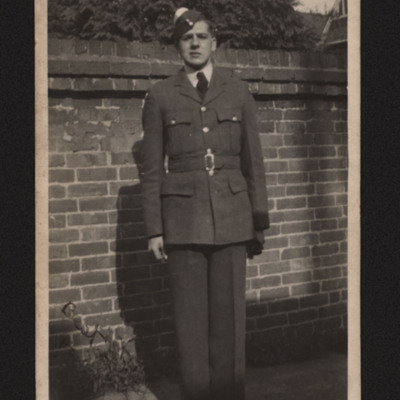 Airman in uniform in front of a wall