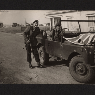 Two men in uniform with Land Rover