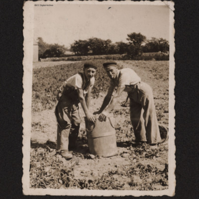 Two men doing agricultural work