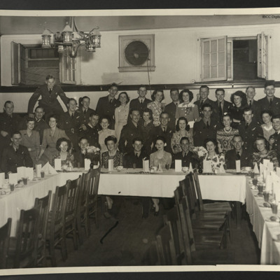 Women and airmen at a graduation party dinner