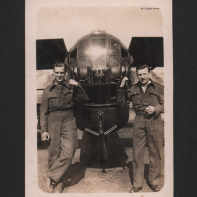 Two men stranding by the rear turret of a Halifax