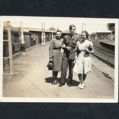 Airman and two women at railway station