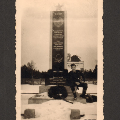 Airman beside Soviet prisoners of war memorial at Bergen-Belsen