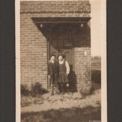 Jim and Sylvia Copus as children in front of a house