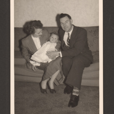 Jim and Sheila Copus and baby sitting on sofa