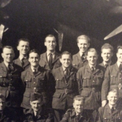 Twelve airmen in front of a Lancaster
