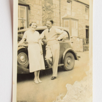 Roy and Mary Chadwick standing by a car