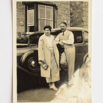 Mary and Roy Chadwick standing in front of car