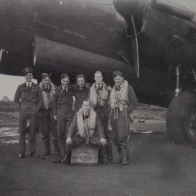 Seven aircrew in front of a Lancaster on dispersal