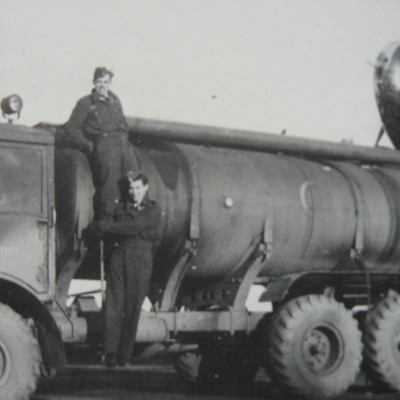 Two airmen standing on a fuel bowser