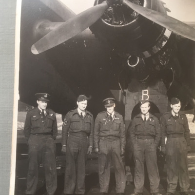 Five airmen under the inner port engine of a Halifax