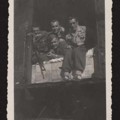 Paolo Troglio and military personnel in a  goods wagon