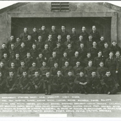 Large group of airman in front of a concrete building