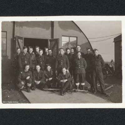 Group of airmen in front of a Nissen hut