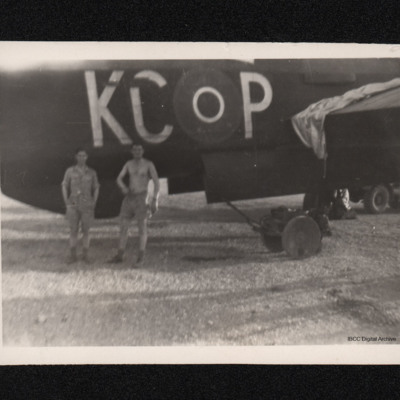 Two servicemen in front of an aircraft