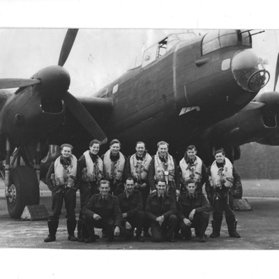 Seven aircrew and four groundcrew in front of a Lancaster